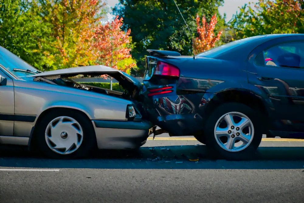 sliver car rear ended into a black car.