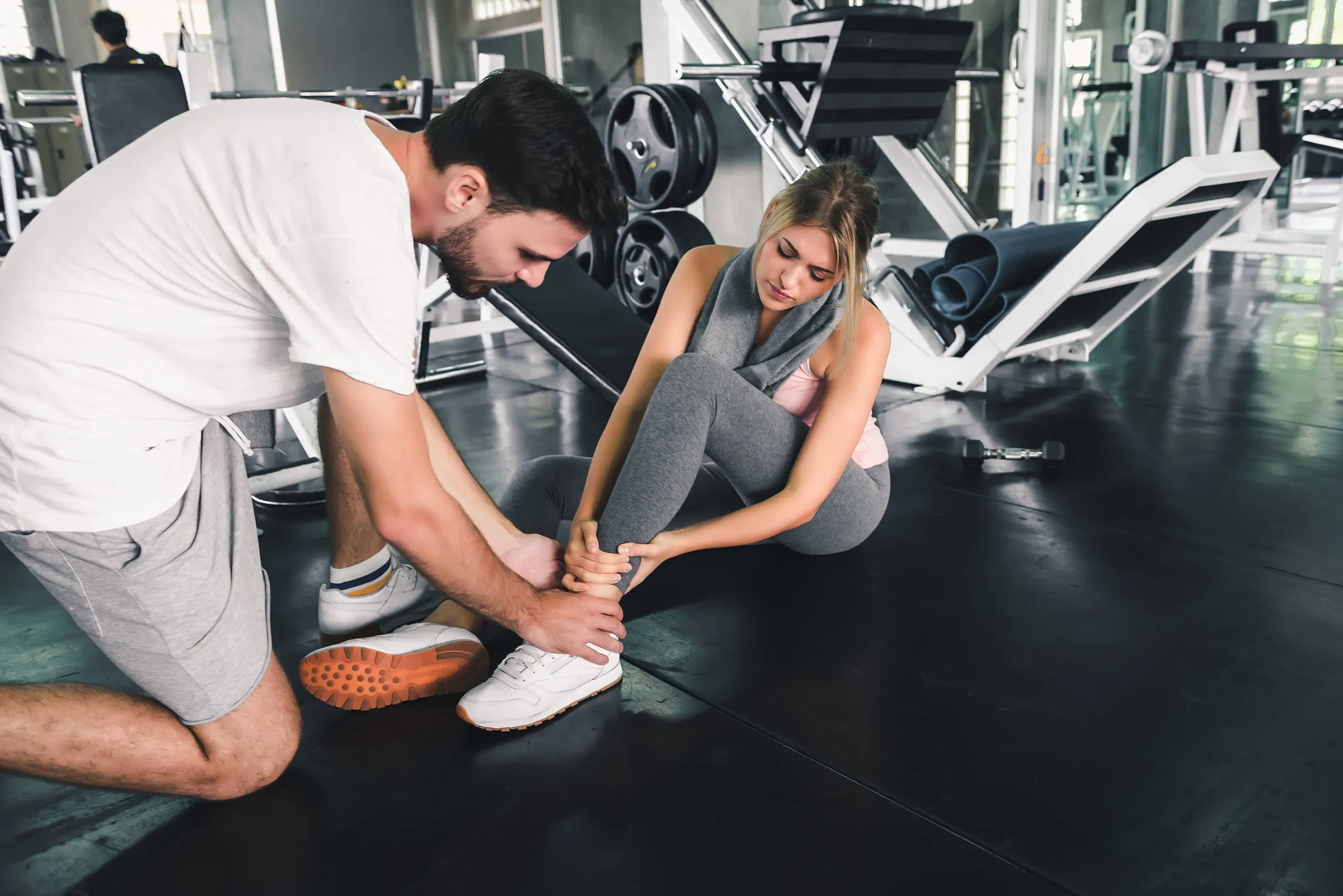 Man helping injured woman in the gym. If you’ve sustained an injury, contact our personal injury attorneys in Casper, WY now.