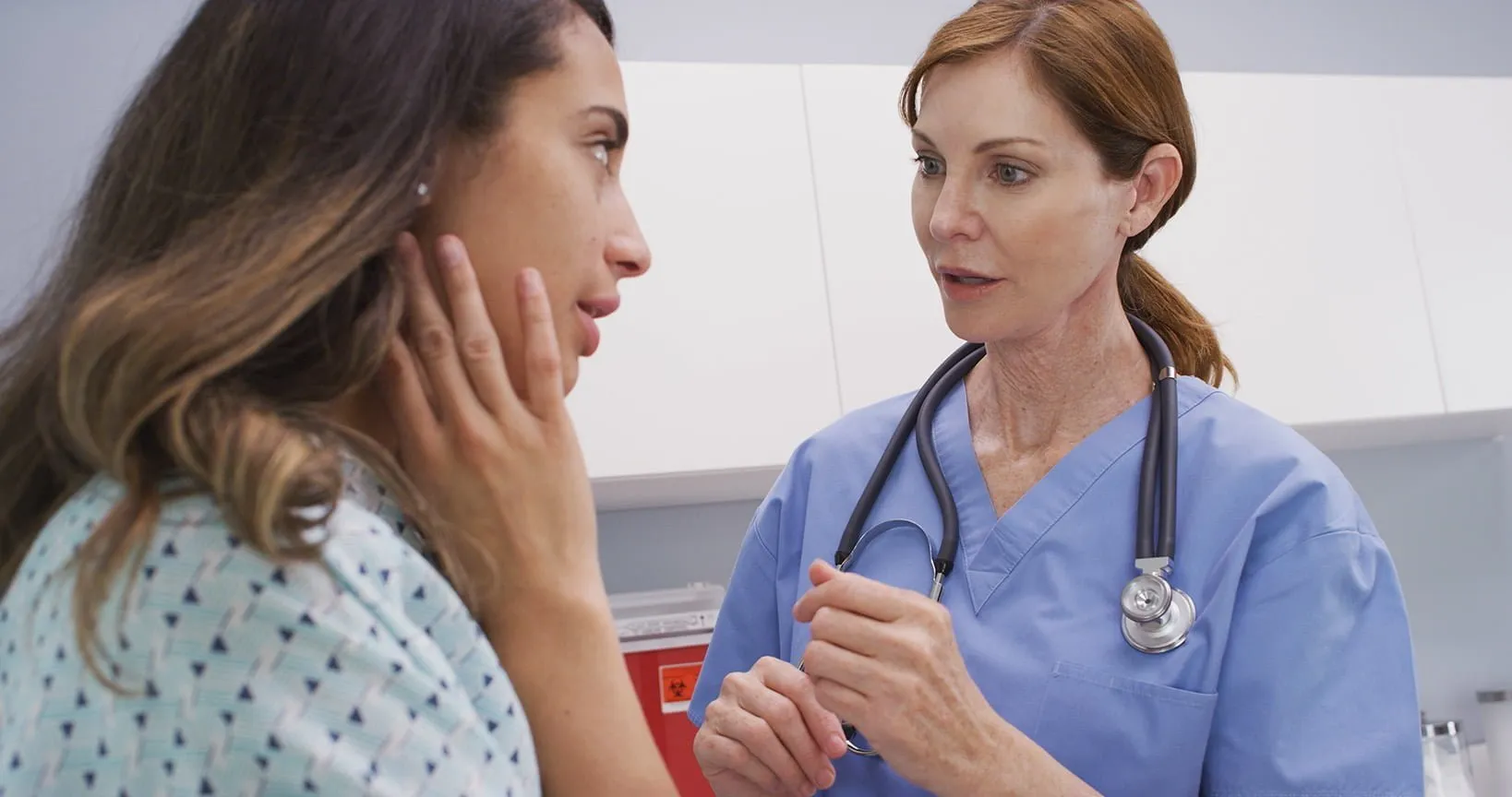 Female doctor talking to female patient in hospital gown. Our Jackson personal injury lawyers know how to fight for those who’ve been injured due to other’s negligence.