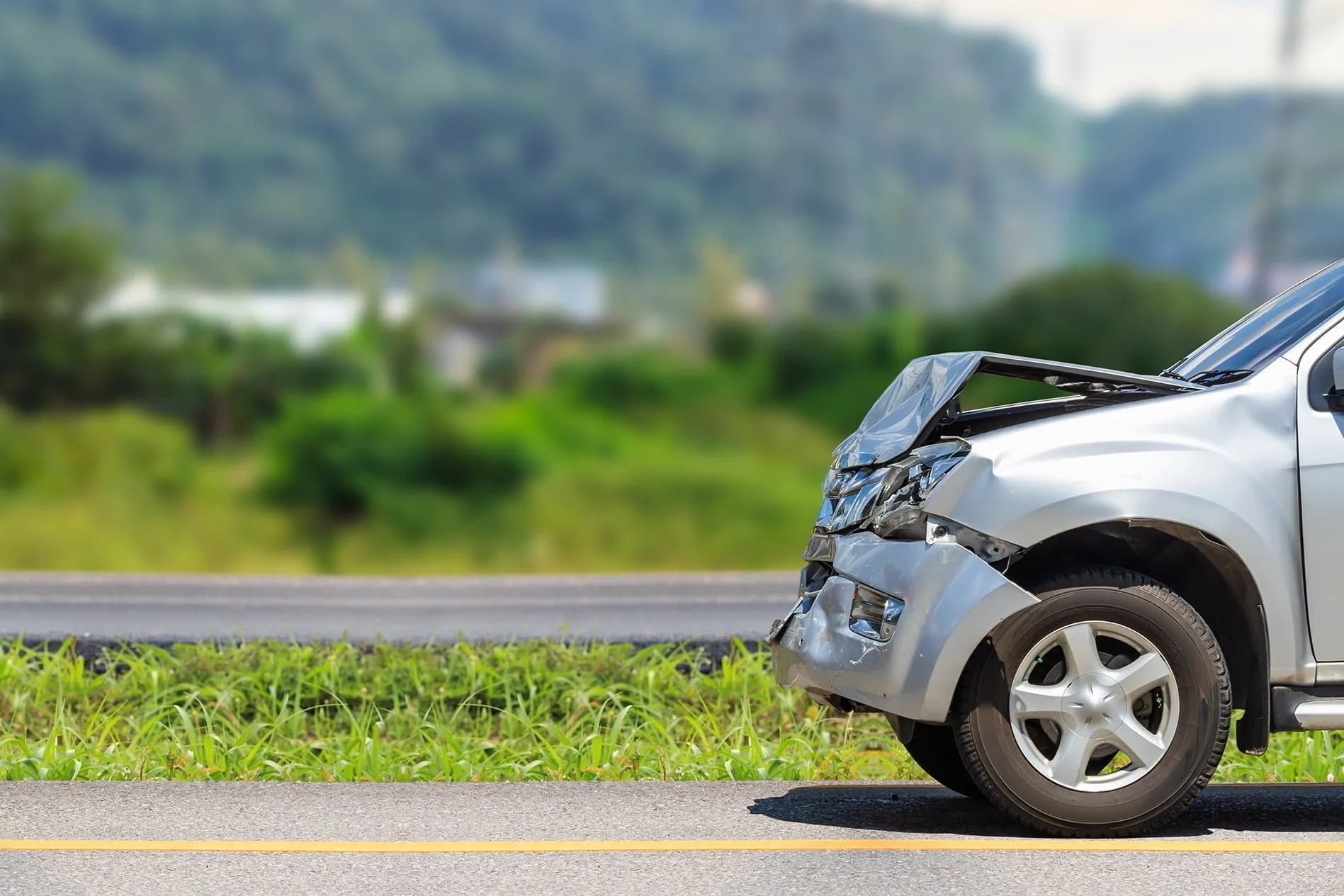Crushed front bumper of car after a car accident. Contact our car accident lawyers today to learn how our car accident lawyers can help you recover damages from a car accident in Jackson or Casper Wyoming.