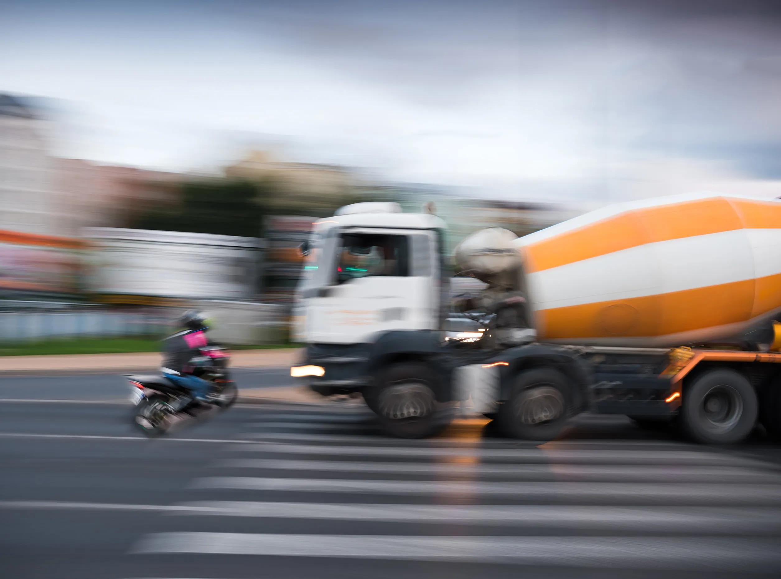 Blurry photo of motorcycle and truck about the get into a collision. Truck accidents can be devastating, but our truck accident lawyers won’t rest until you get the compensation you deserve.