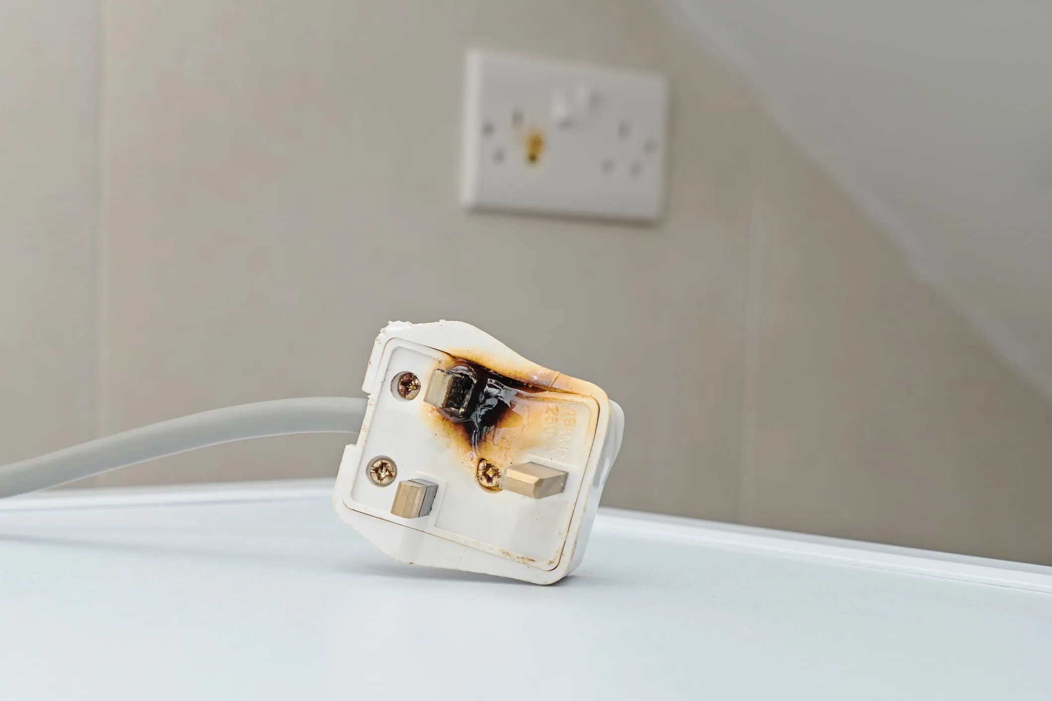 Burnt plug sitting on a table. If you’ve been injured by a defective or dangerous product, our Wyoming product liability lawyers can help you pursue the compensation you deserve. 