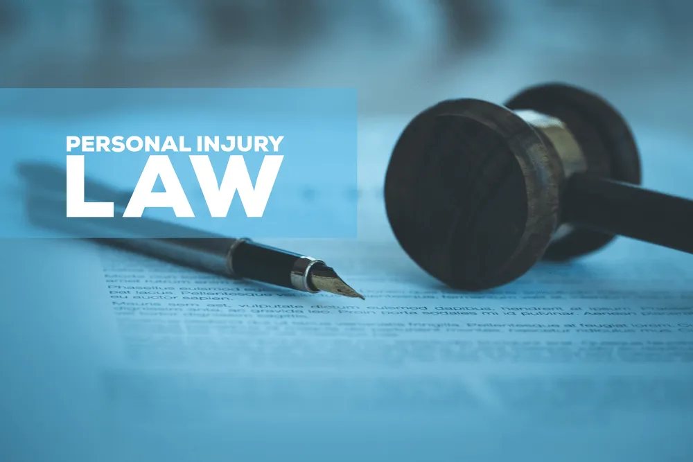 gavel on a paper with a pen and the words "personal injury law" in over them.