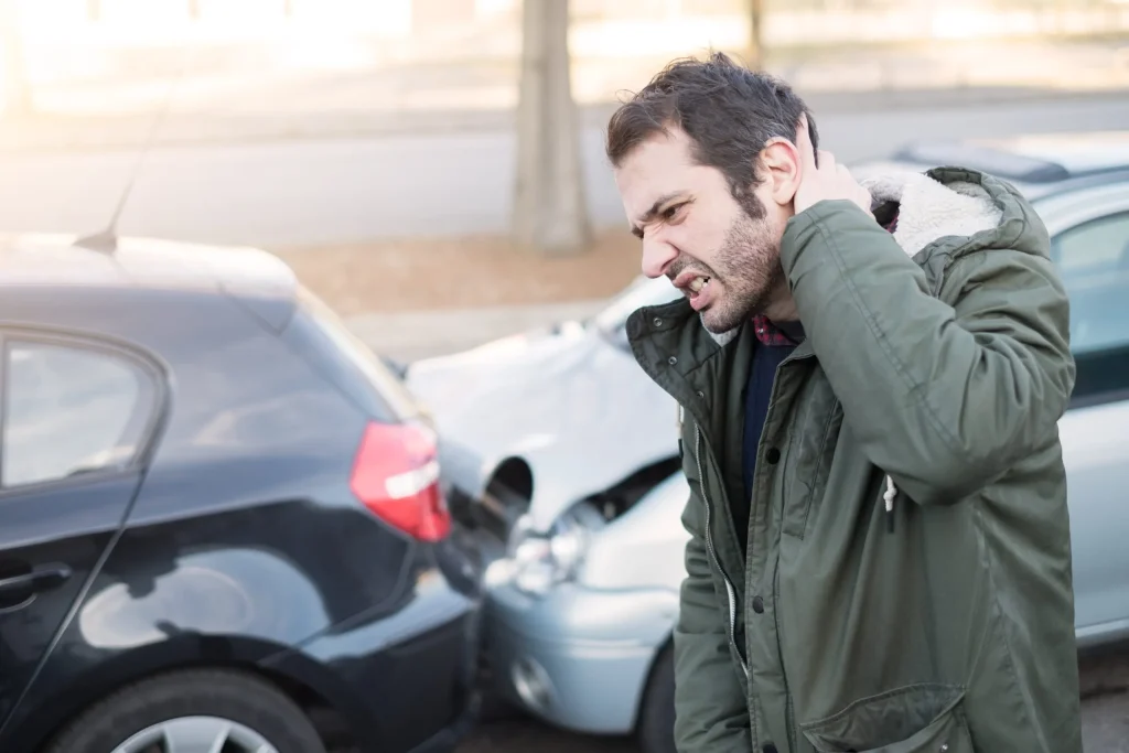 A man holding his neck after a car accident injury. Our personal injury lawyers in Casper, WY are experienced representing victims of an auto accident.