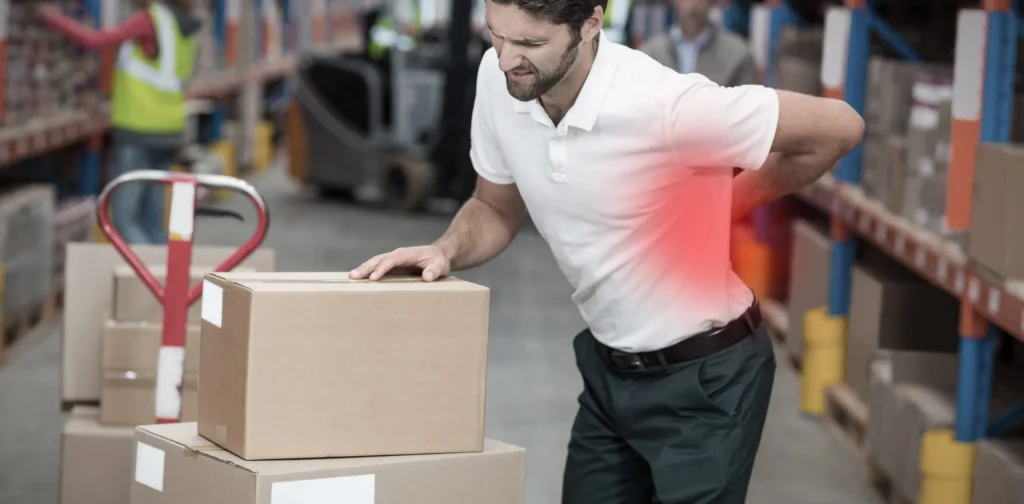 A man who has suffered a work injury while trying to lift boxes. Our personal injury attorney in Cheyenne, WY will fight for the compensation you deserve if you have experienced a work injury