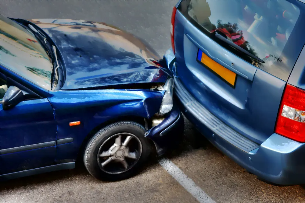 Blue car re ended a blue van. The car is damaged and smashed in.