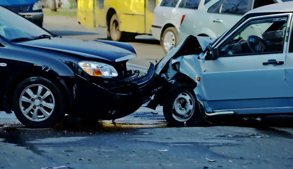 two cars whose pumpers smashed into each other on the street. the cars are very damaged.