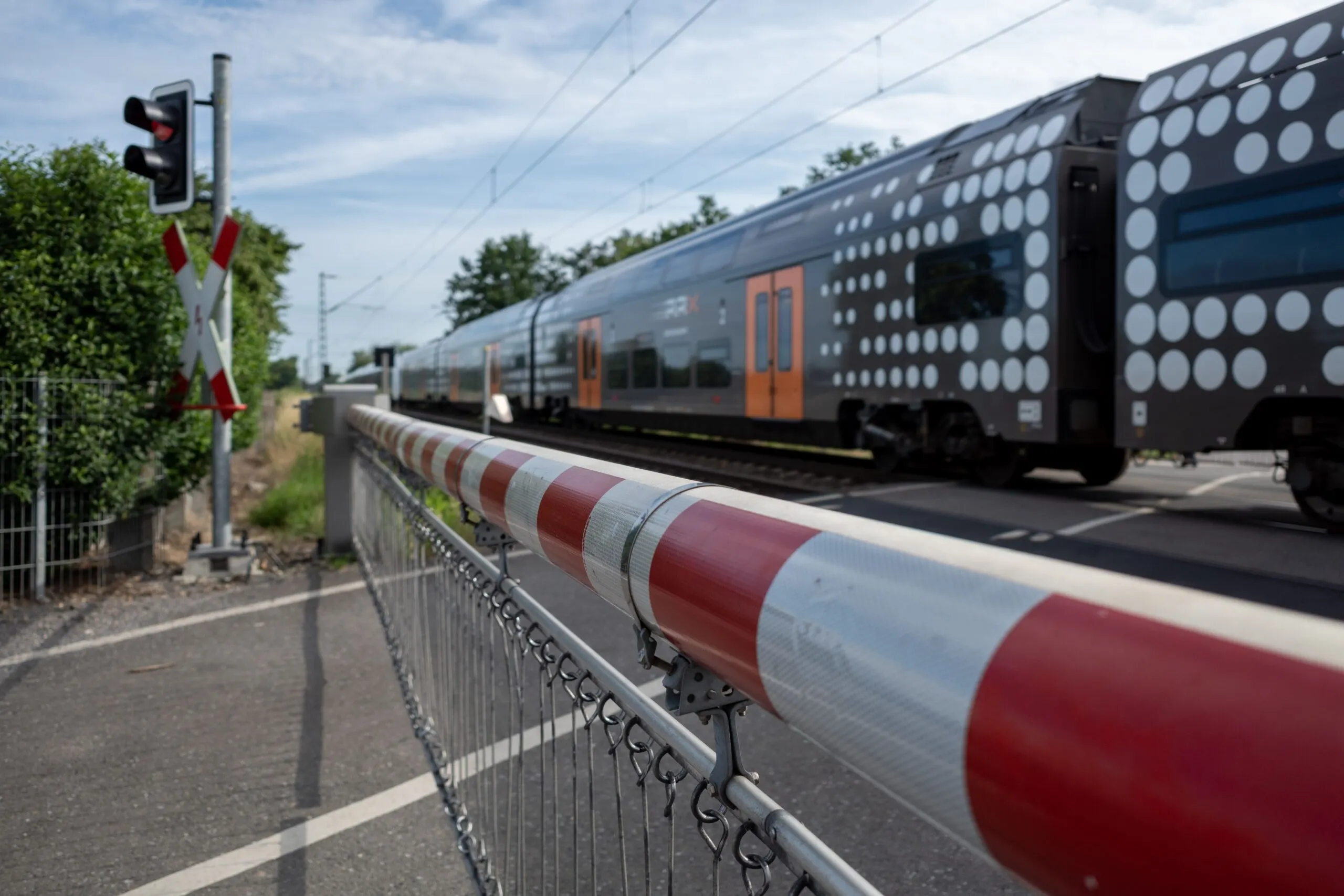 Railway crossing safety arms are down while a train passes through. If you’ve been injured in a train accident, contact us for a strong Wyoming train accident lawyer representative.
