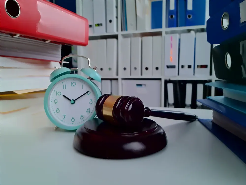 gavel and alarm clock in a law library,