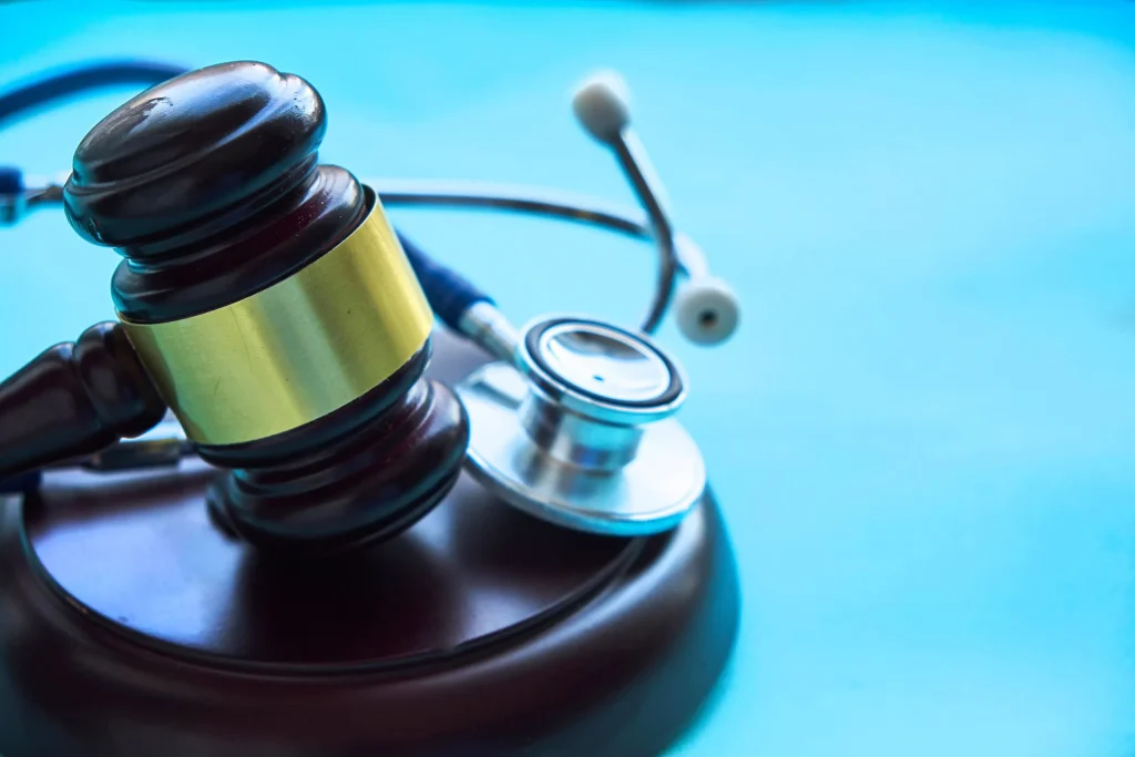 Wooden gavel and stethoscope sit next to each other. Contact us for a strong personal injury lawyer who will fight to get you the compensation you deserve.
