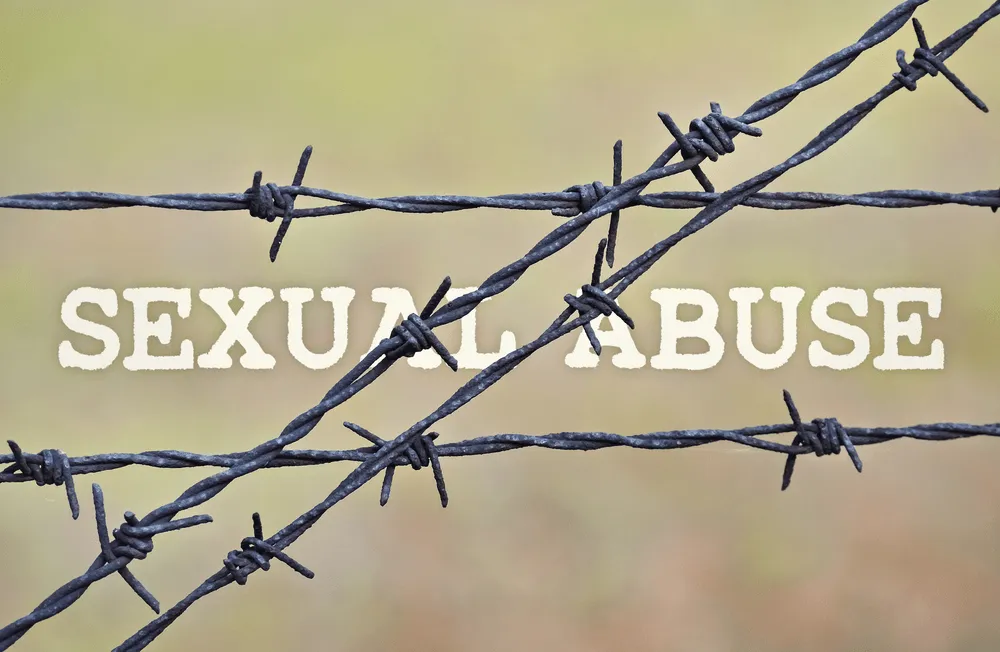 barbed wire over the words "sexual abuse".