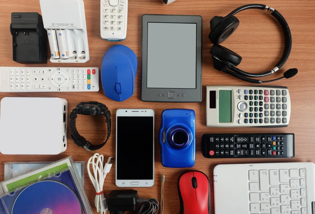 A pile of electronic products on a desk.